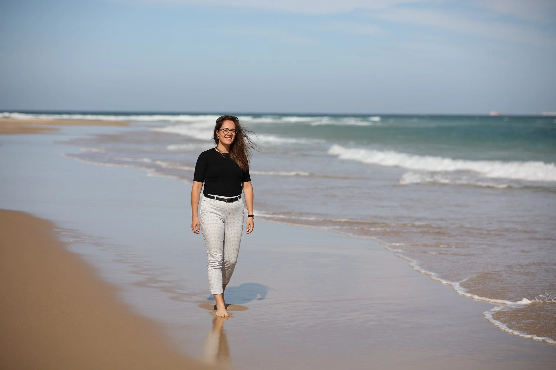 Melanie Will walking along a South African beach