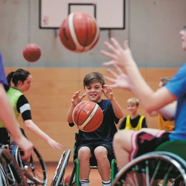 Wheelchair users playing basketball