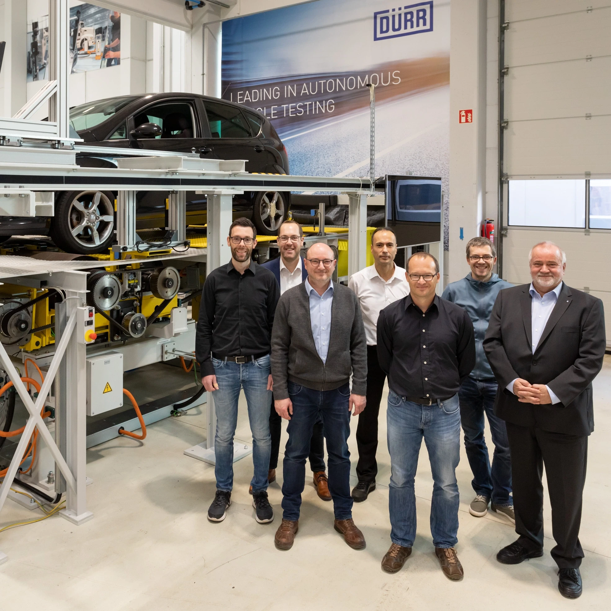 employees in front of x-road curve