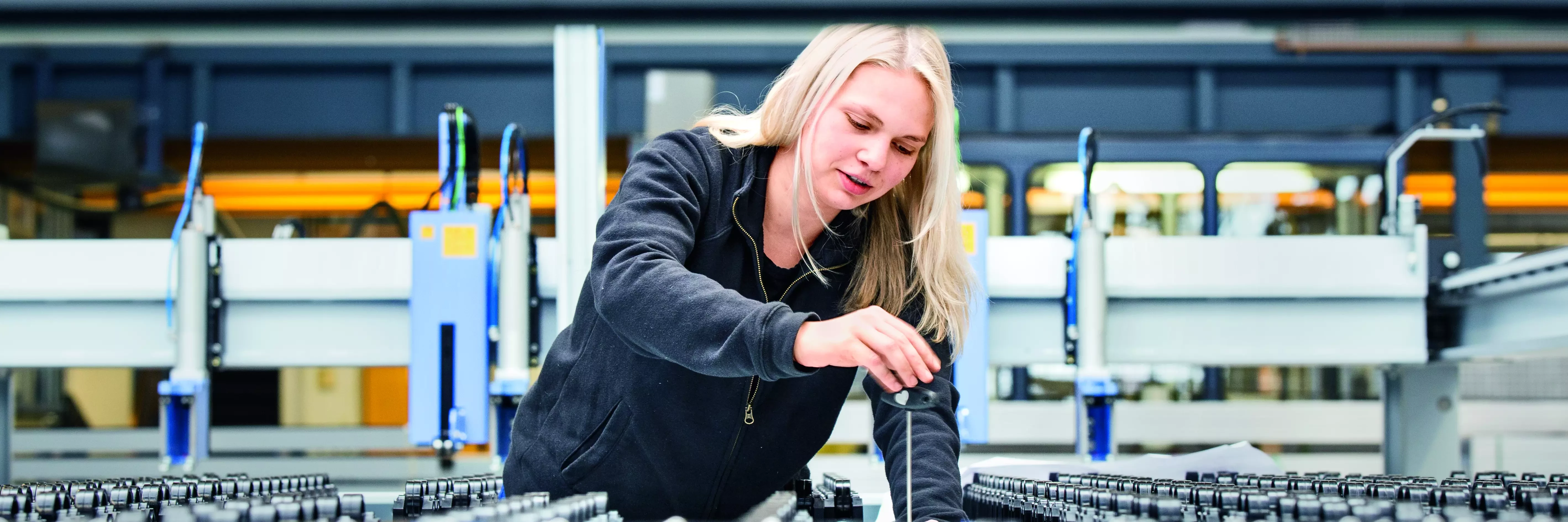 Vocational training apprentice working on a machine