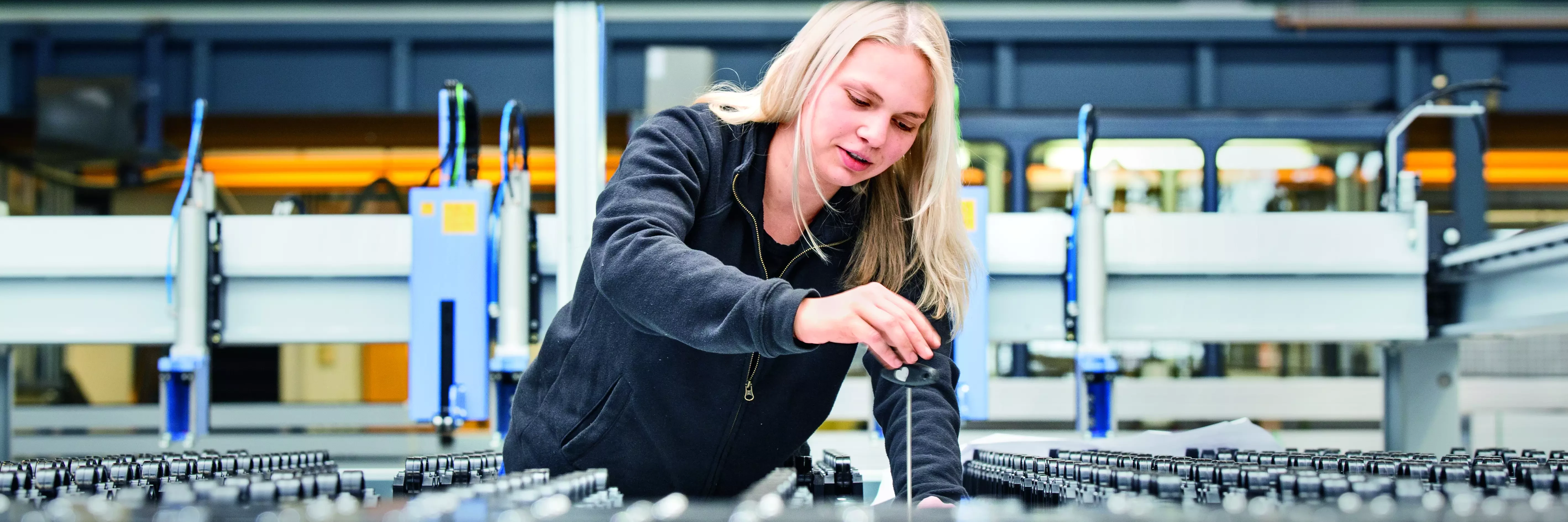 Vocational training apprentice working on a machine