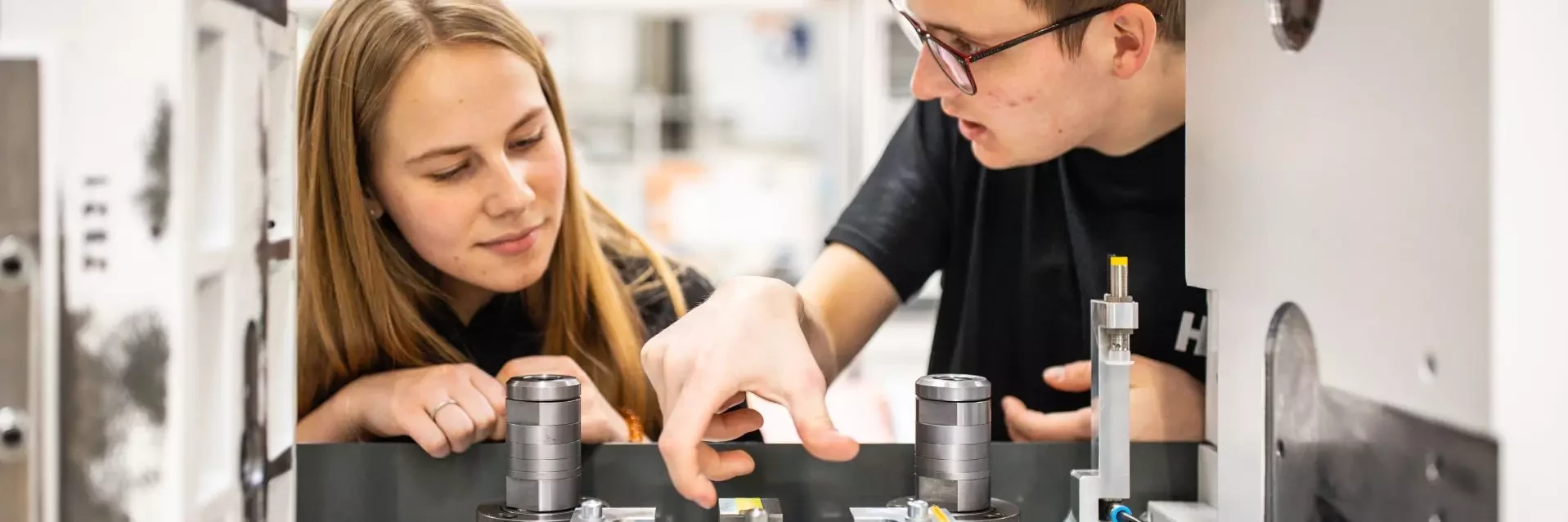 Apprentices working on a machine