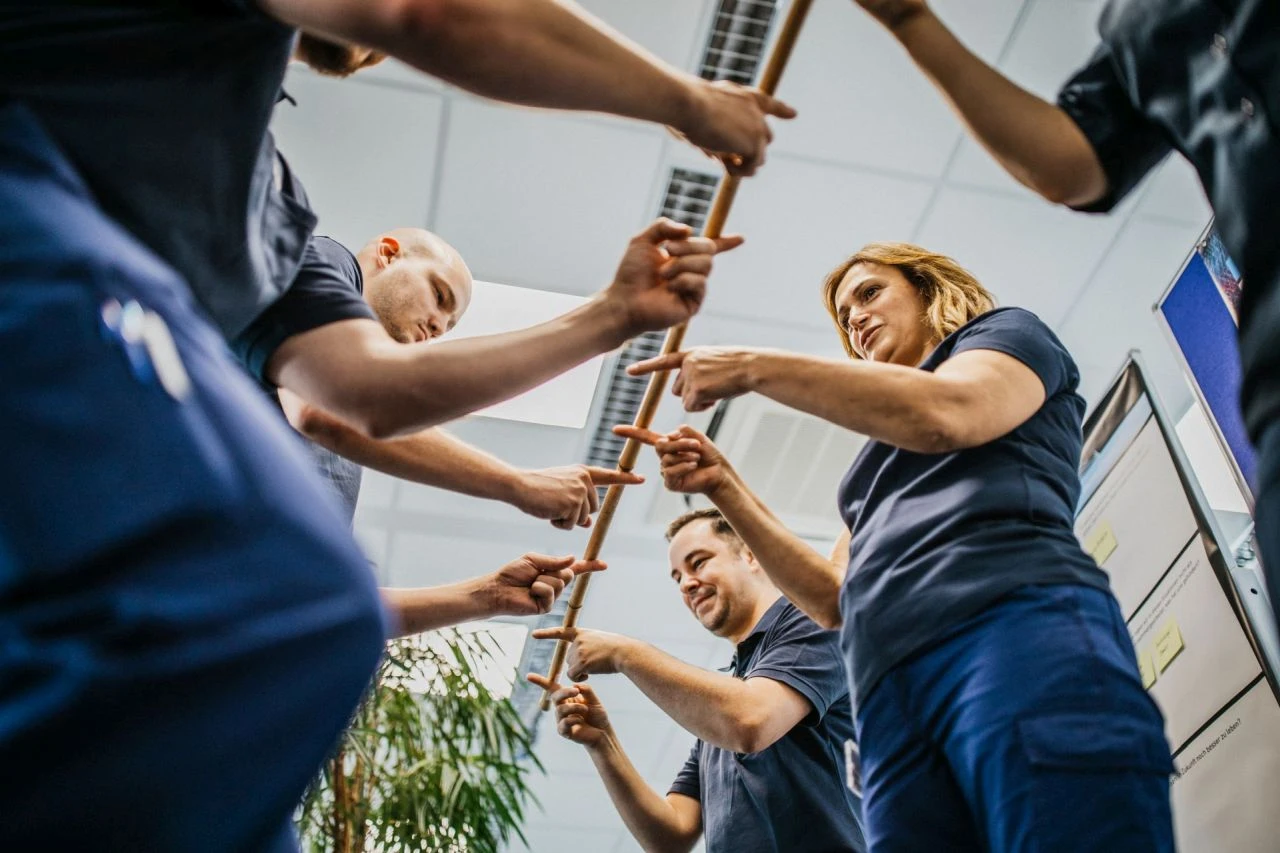 Teamwork exercise with bamboo stick