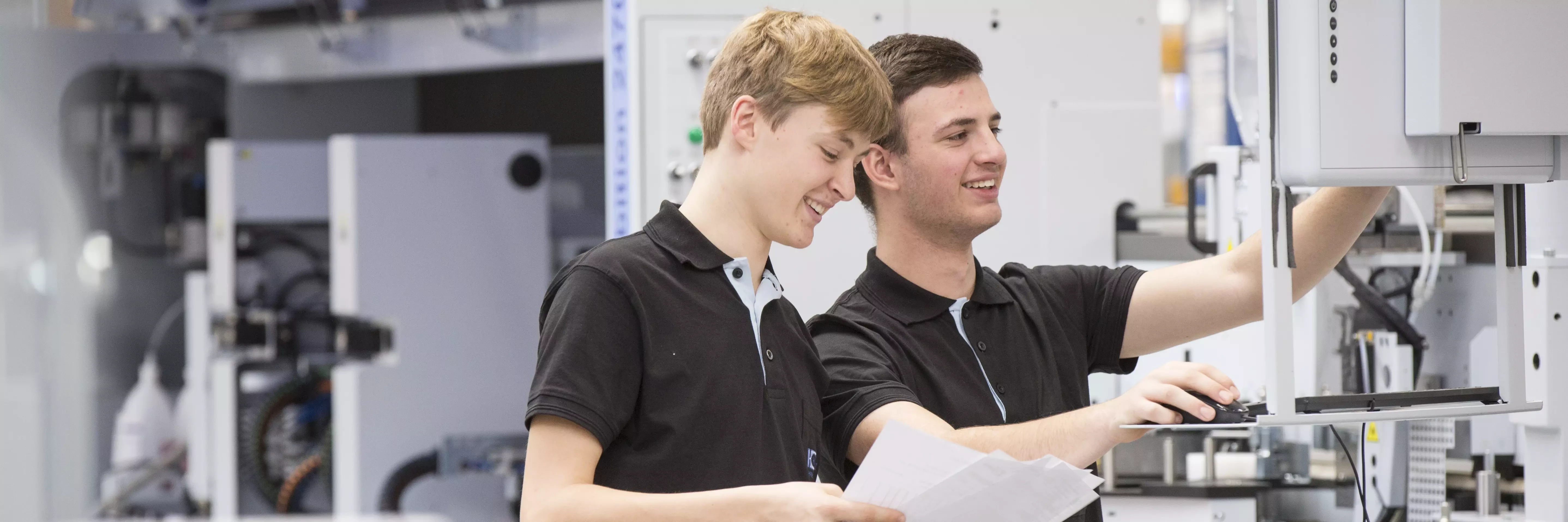 Vocational Training apprentices working on a machine