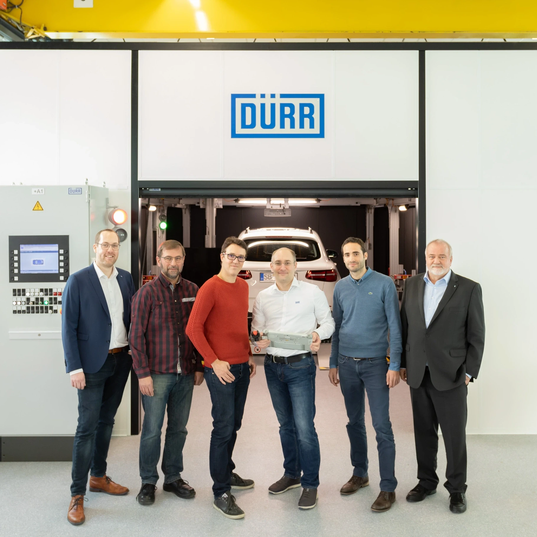 Employees in front of end-of-line test area