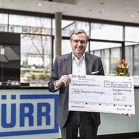 Jochen Weyrauch with donation cheque