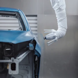 Paint application robot painting a car