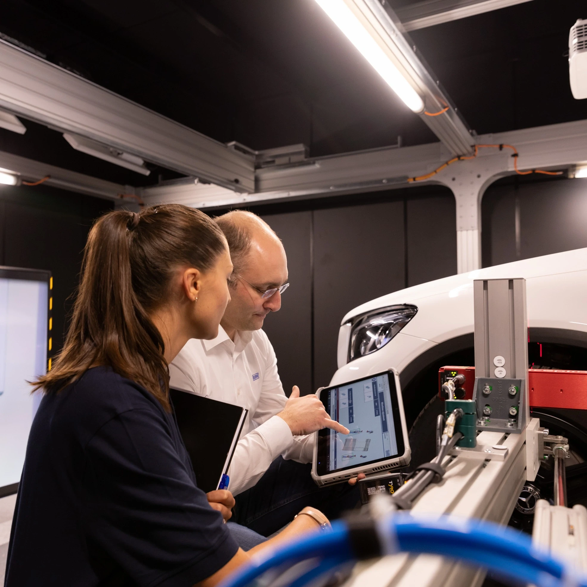 Employees work on x-around stand