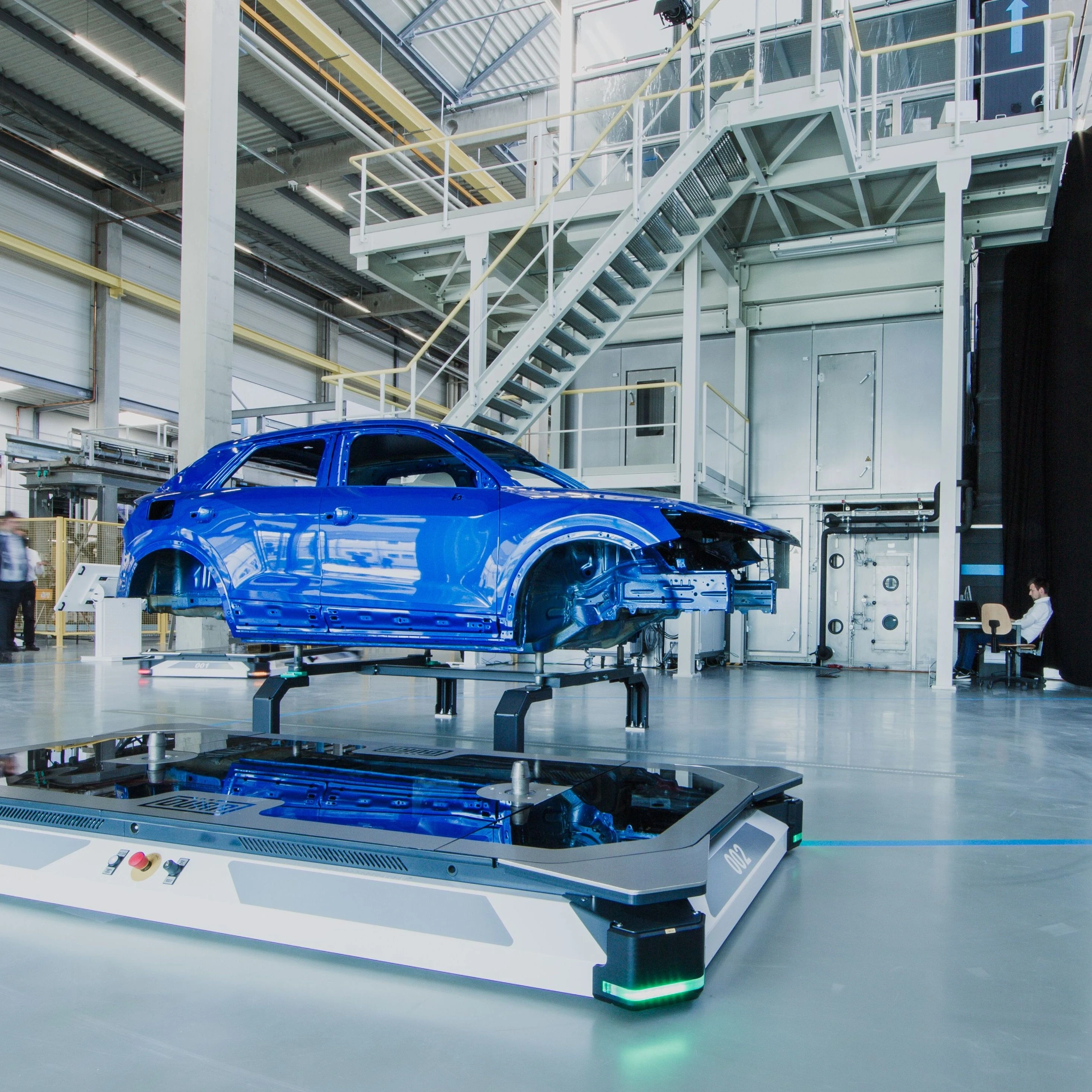 blue car body in a factory hall