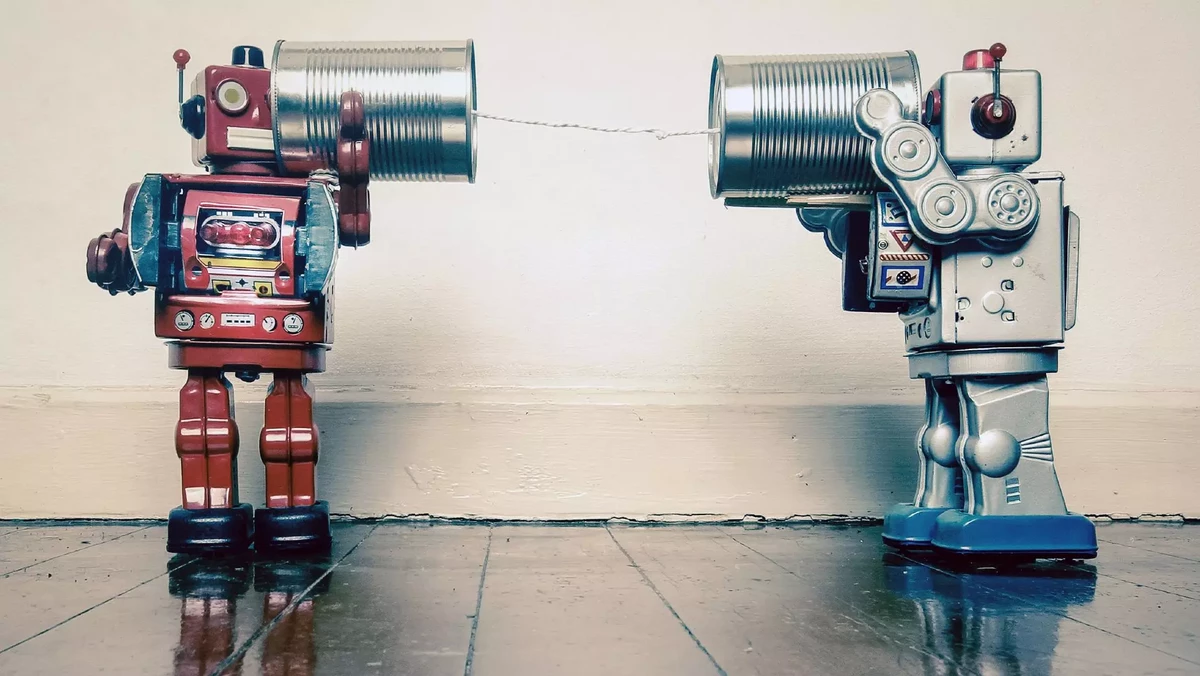 toy robots communicating with tin can telephone