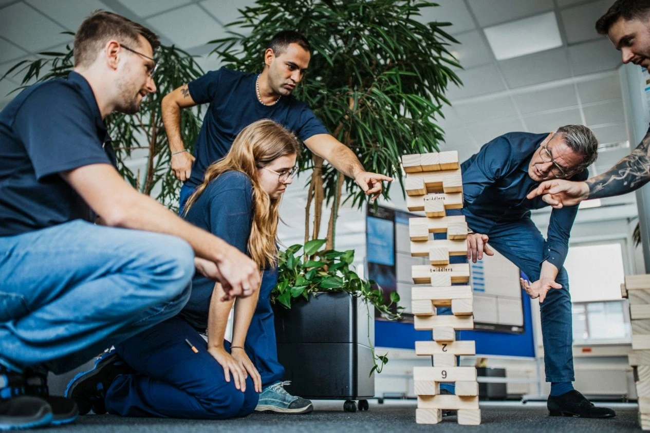 Dr. Jochen Weyrauch and participants at the tower of building blocks