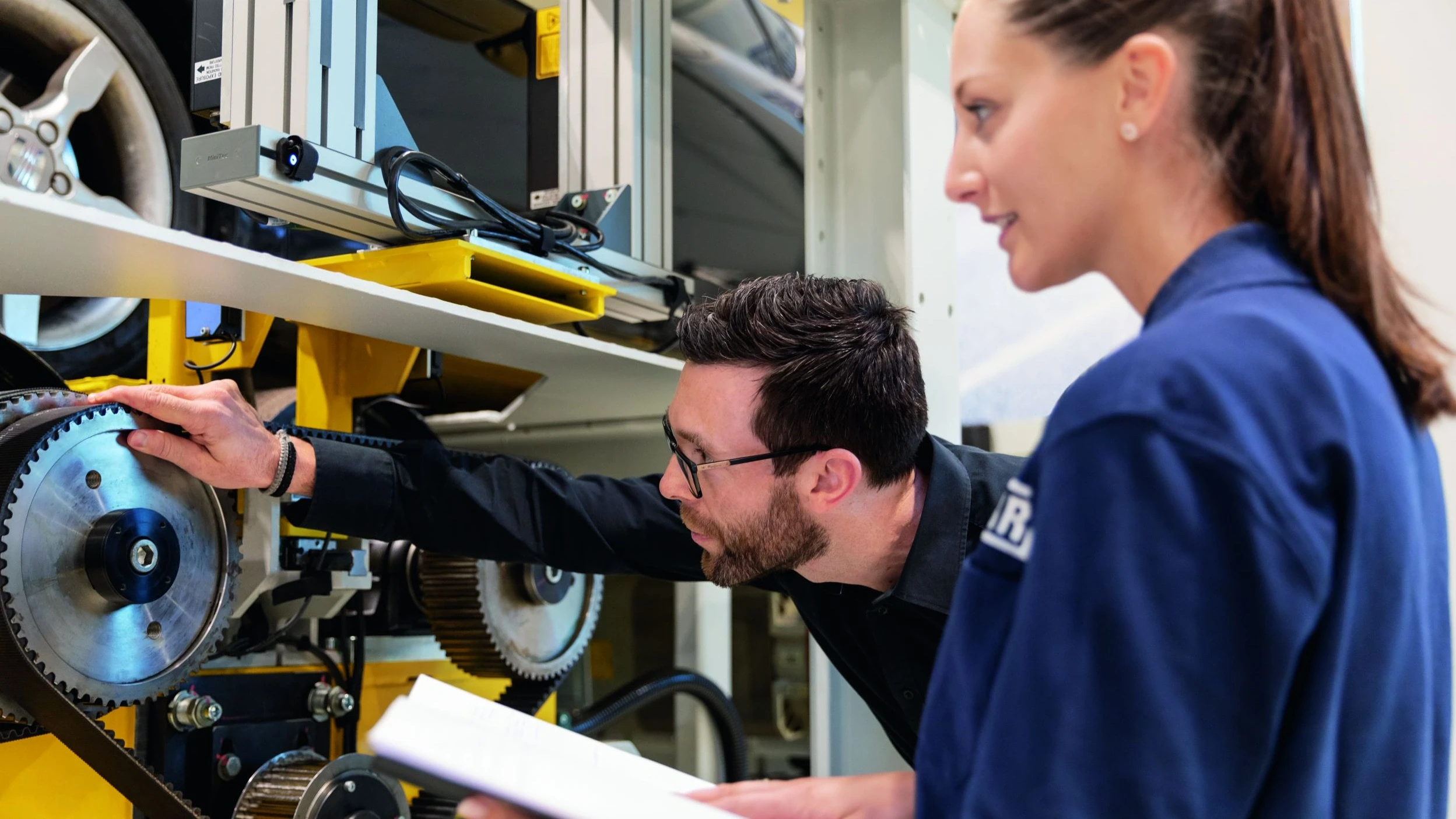 Employees working on cogwheels