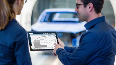 Employees using digital features on a tablet