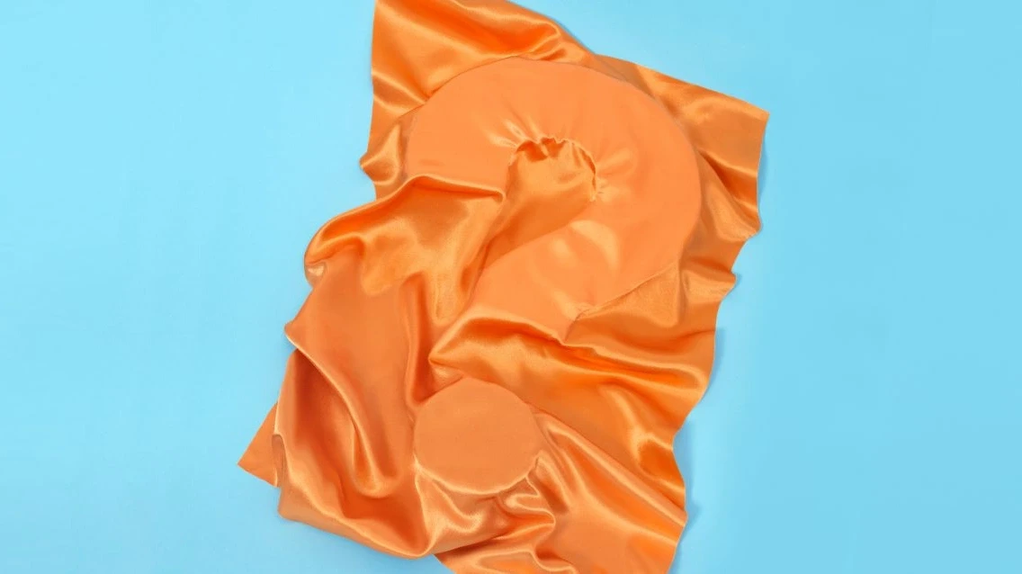 ECO cover picture of a questionmark covered by orange textile