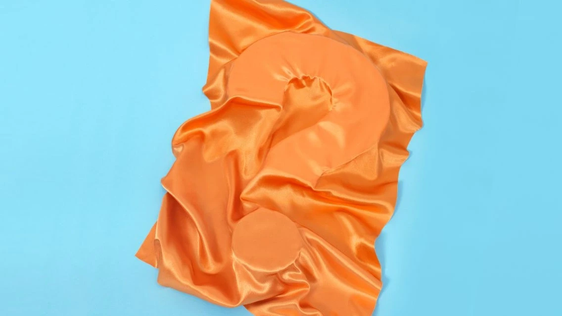 ECO cover picture of a questionmark covered by orange textile