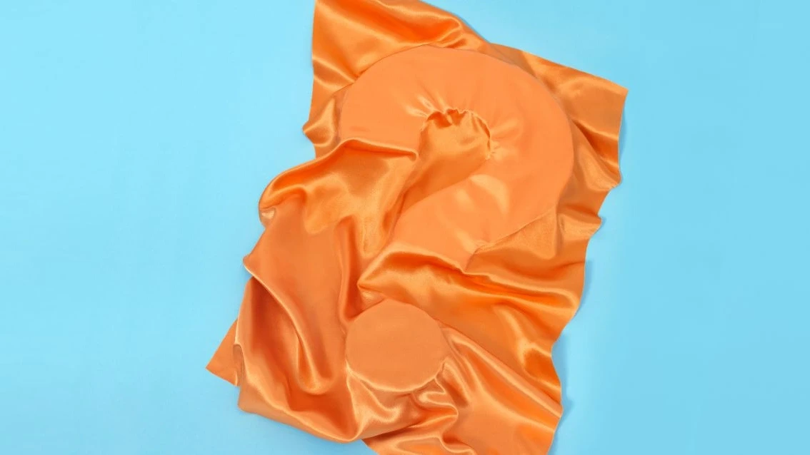 ECO cover picture of a questionmark covered by orange textile