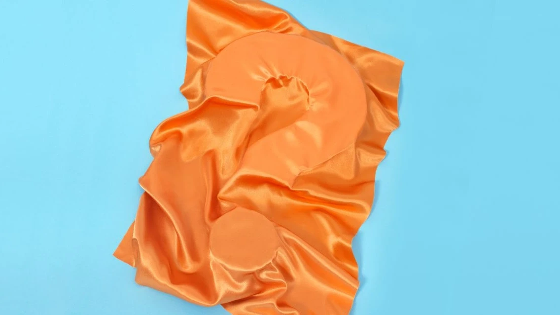 ECO Coverbild Fragezeichen mit orangefarbenem Stoff verdeckt