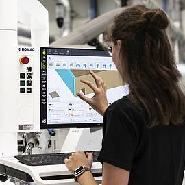 Employee operates software for edge banding machines
