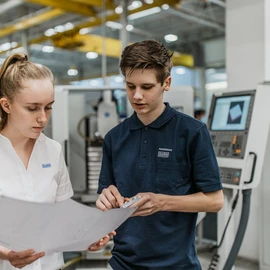 Apprentices looking at a plan