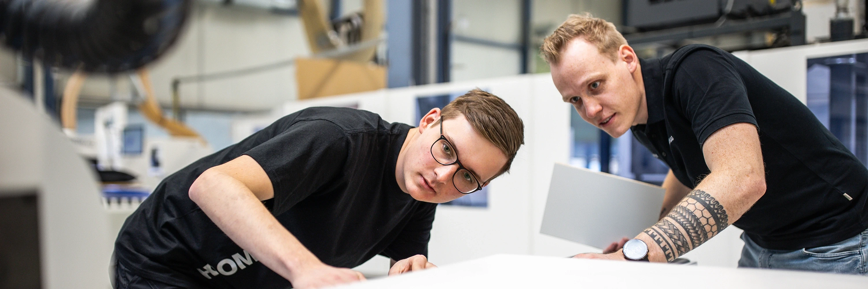 Apprentices working on a machine