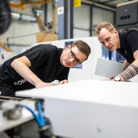 Apprentices working on a machine